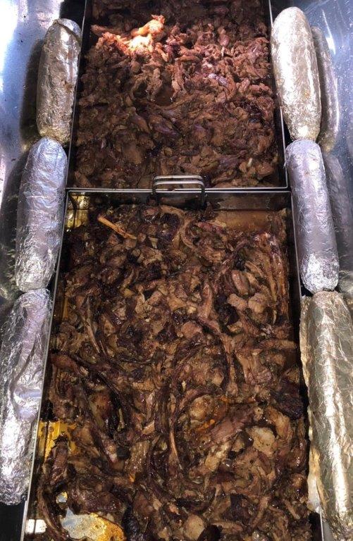 Carved spit-braai lamb in serving trays, ready to plate
